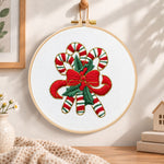 Christmas striped candy cane embroidery hoop wall art displayed as warm and cozy handmade home decor