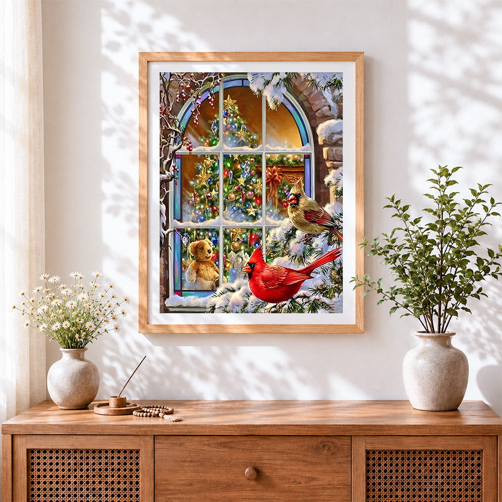 Finished christmas tree and red cardinals cross stitch artwork displayed