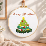 Christmas tree greeting embroidery hoop wall art displayed as warm and cosy handmade home decor
