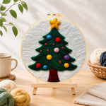 Finished christmas tree with colourful baubles needle felting displayed on a wooden easel