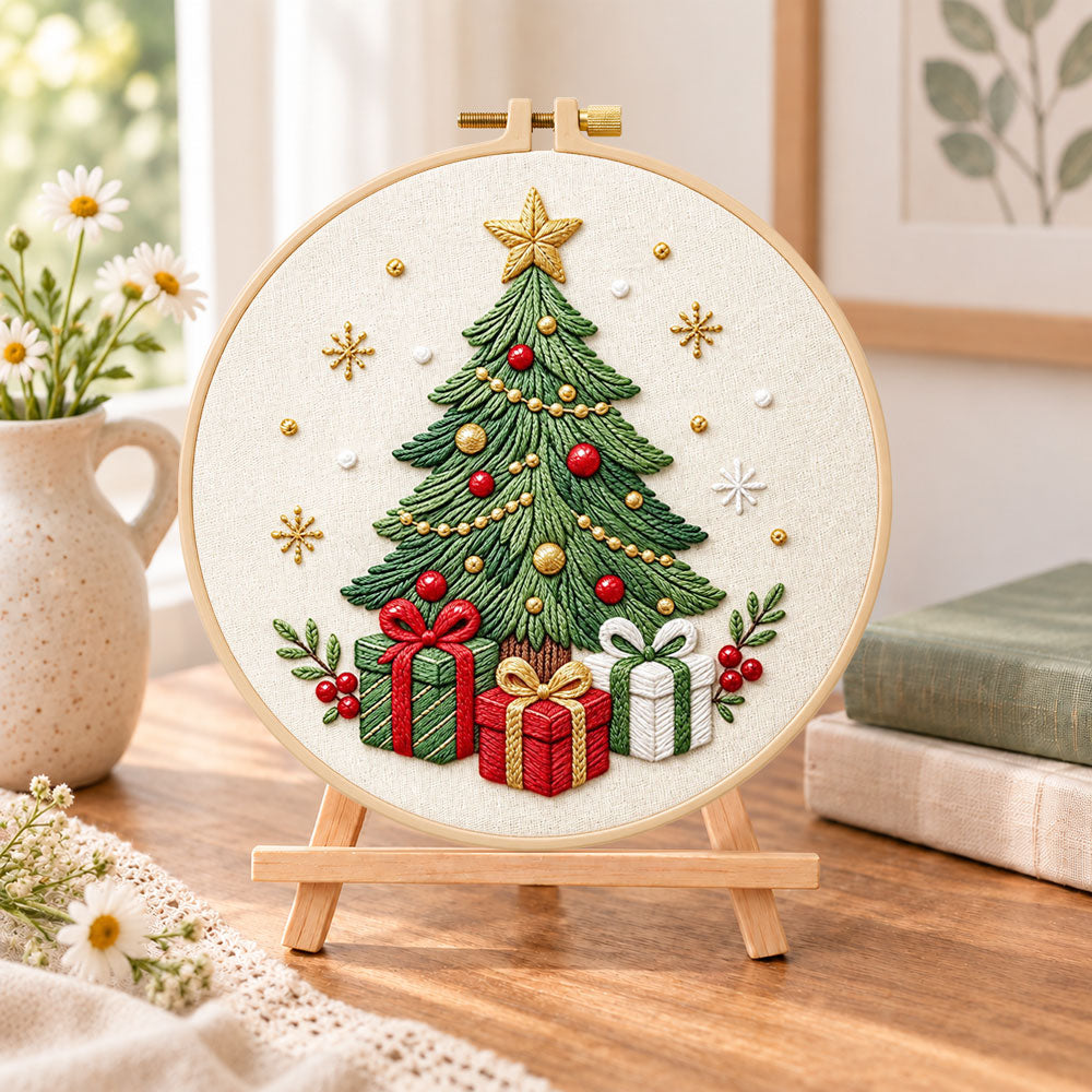 Christmas tree with gifts embroidery kit finished hoop displayed on a wooden stand as cosy tabletop decor
