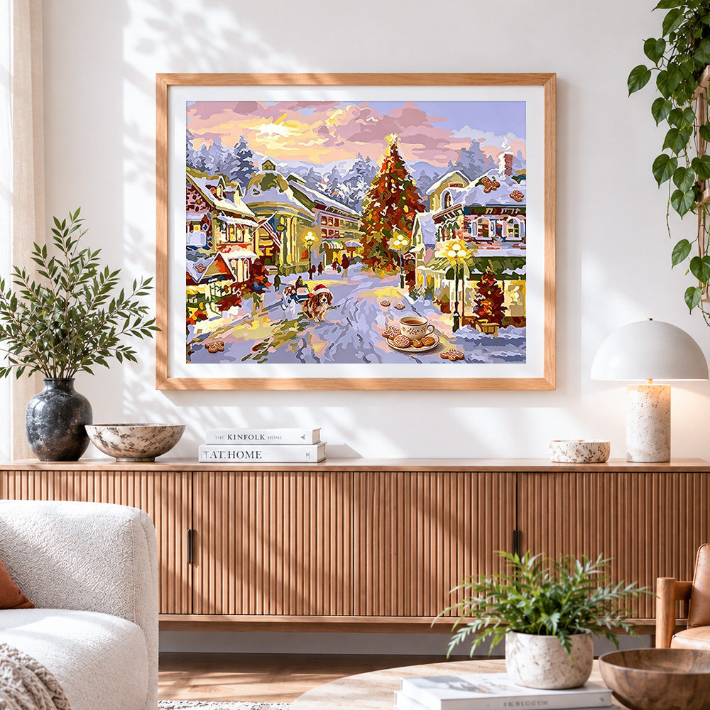 Finished christmas village scene with gingerbread and tree cross stitch artwork displayed