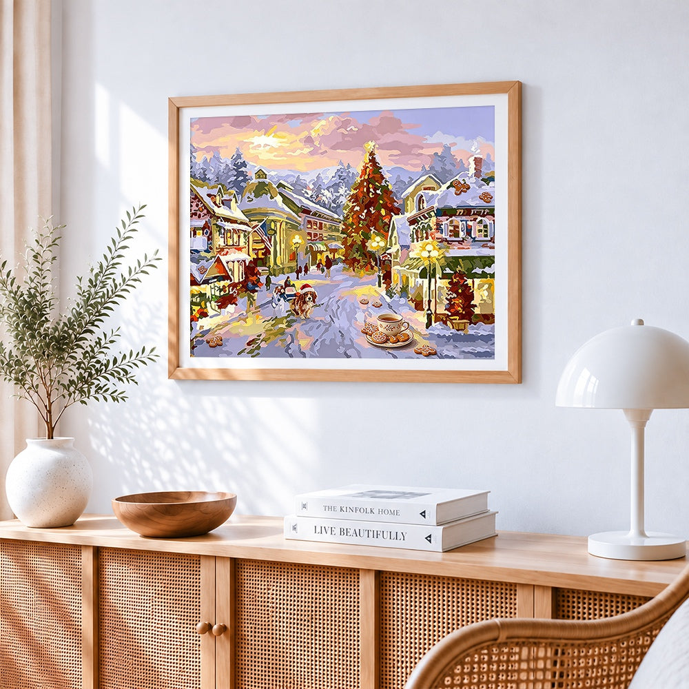 Christmas village scene with gingerbread and tree cross stitch artwork displayed on wall as home decor