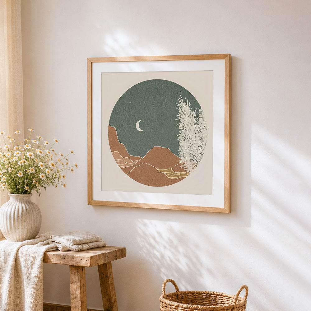Circular minimalist landscape and moon cross stitch artwork displayed on wall as home decor