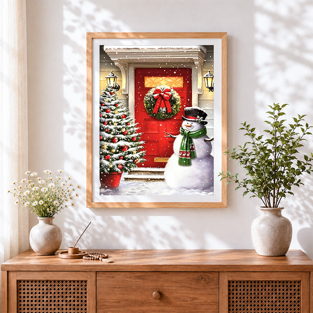 Finished classic snowman and red door cross stitch artwork displayed