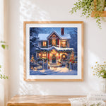 Finished classic snowy house at christmas cross stitch artwork displayed
