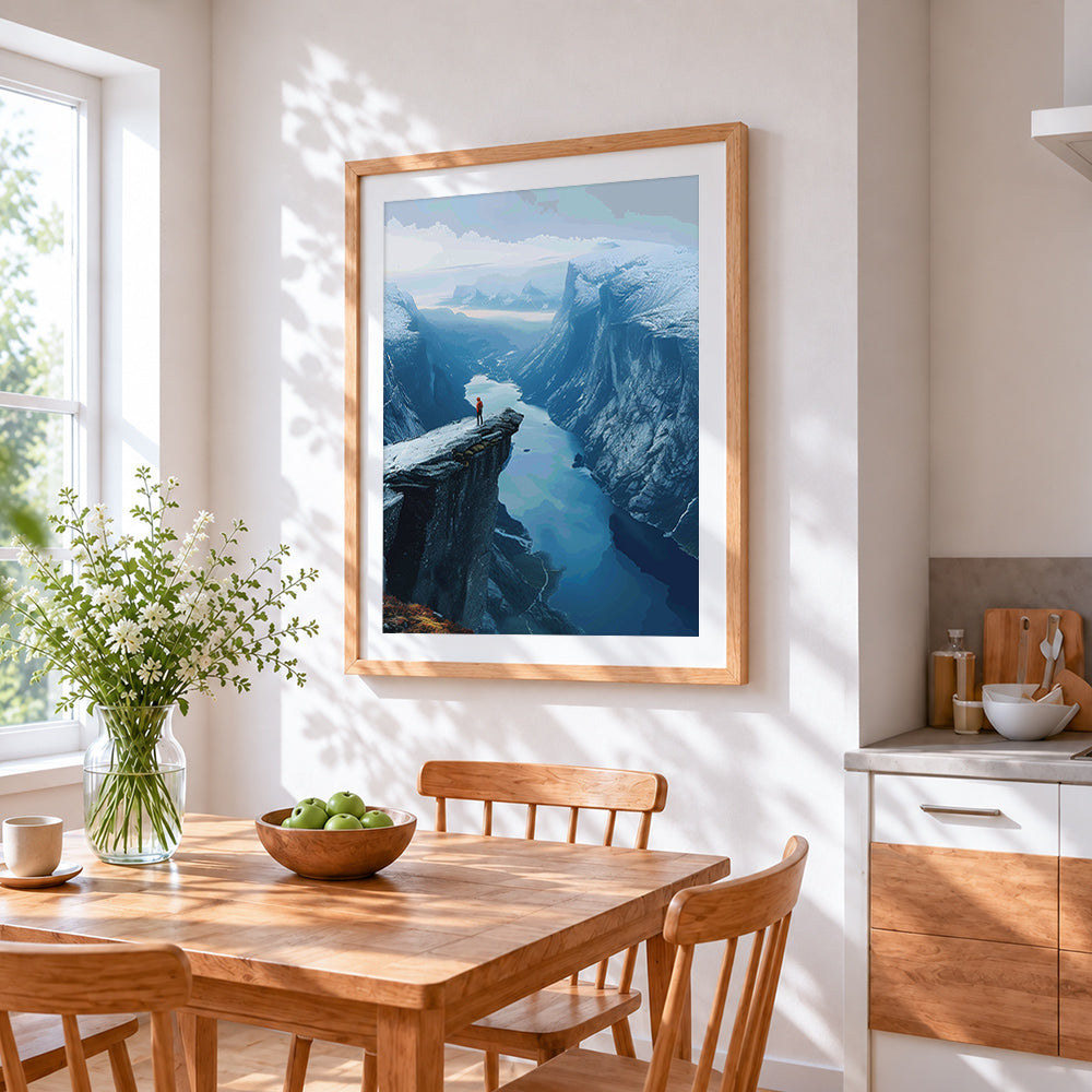 Cliff edge over fjord cross stitch artwork displayed on wall as home decor