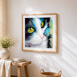 Close-up cat with a blue butterfly cross stitch artwork displayed on wall as home decor
