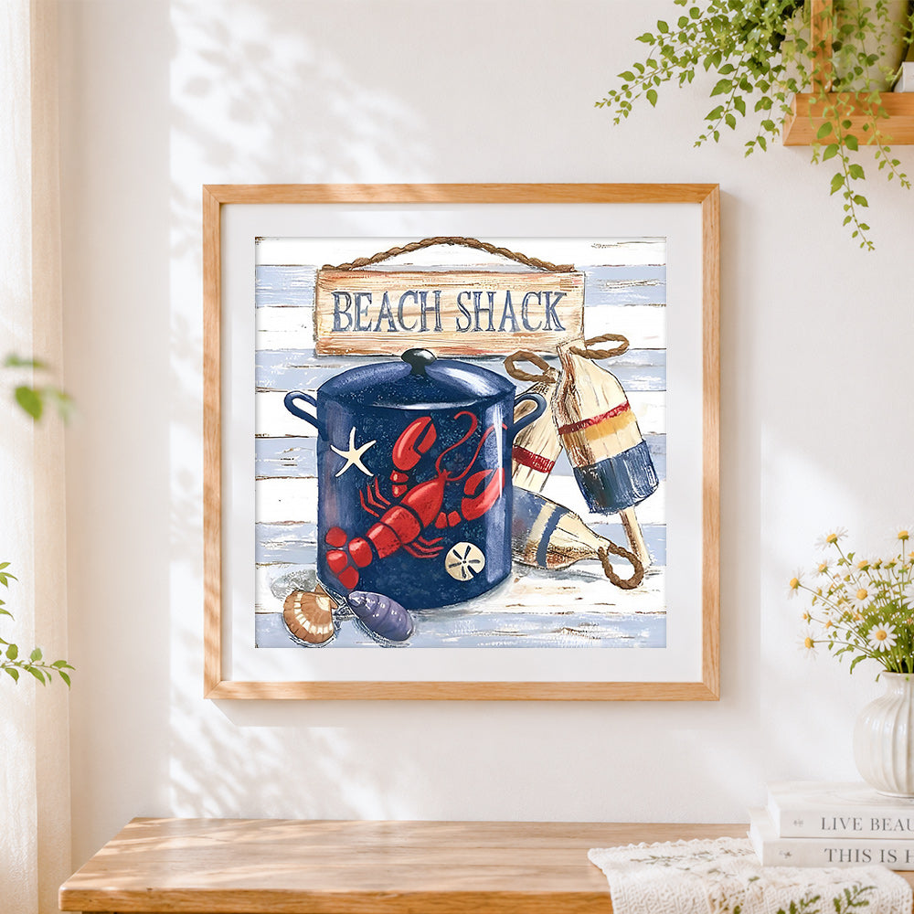 Finished coastal beach shack still life cross stitch artwork displayed