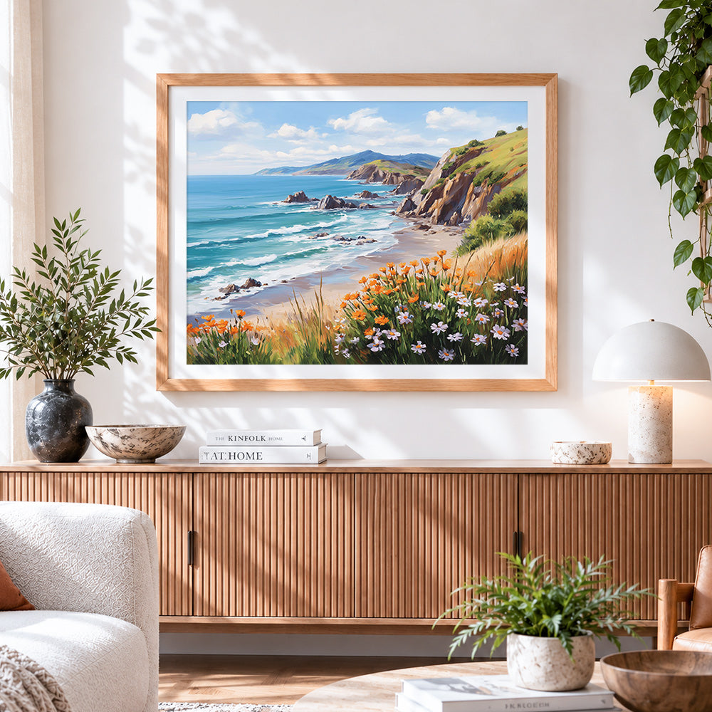 Finished coastal cliffs and wildflowers cross stitch artwork displayed