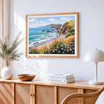 Coastal cliffs and wildflowers cross stitch artwork displayed on wall as home decor