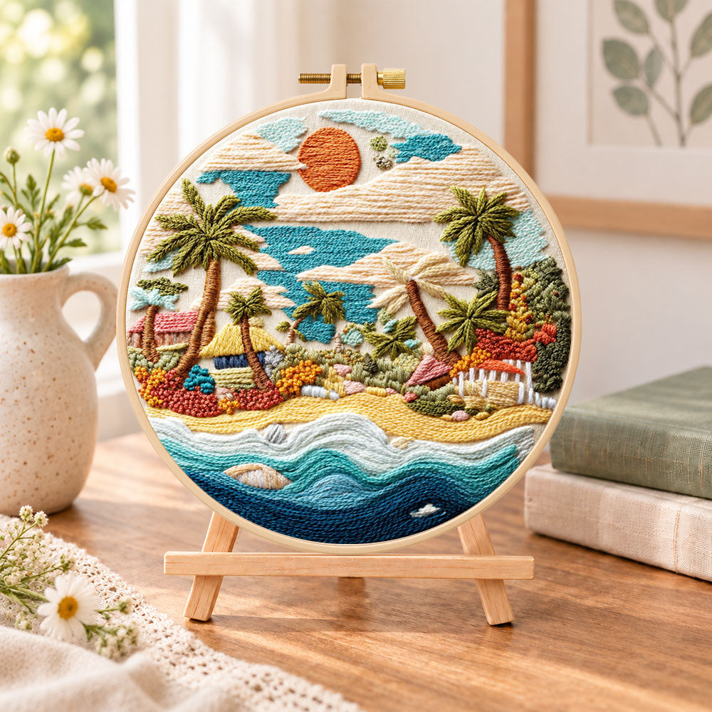 Coastal sunset cove embroidery kit finished hoop displayed on a wooden stand as cosy tabletop decor