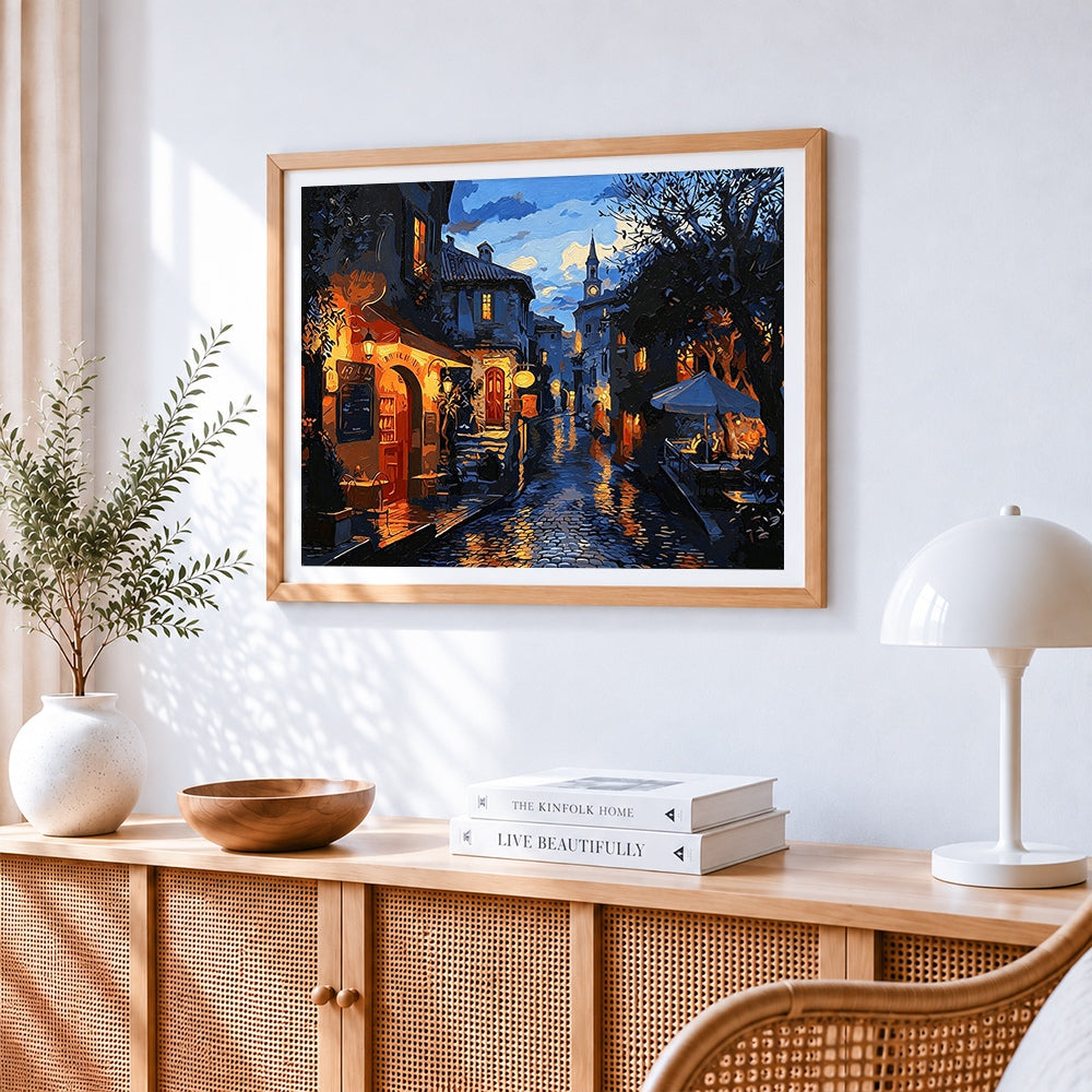 Cobblestone street at night cross stitch artwork displayed on wall as home decor