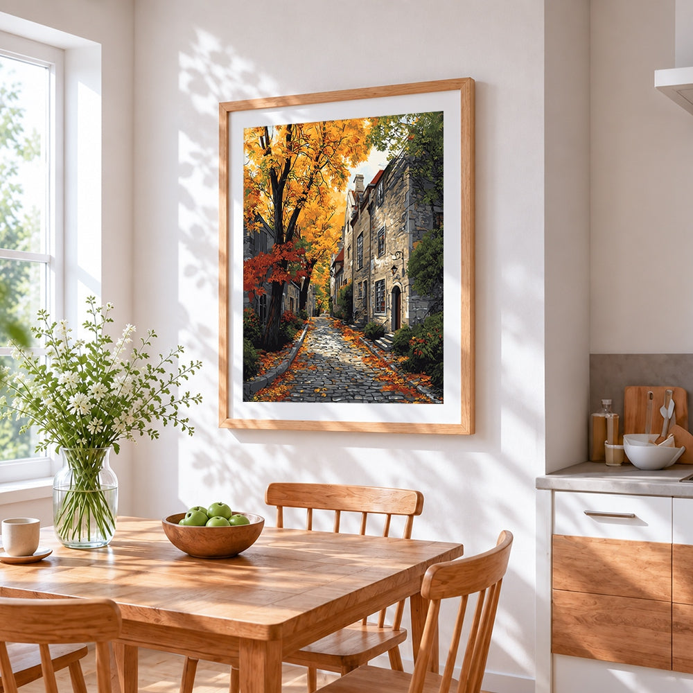 Cobblestone street in autumn cross stitch artwork displayed on wall as home decor