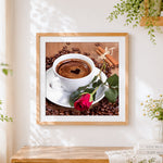 Finished coffee and red rose cross stitch artwork displayed