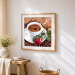 Coffee and red rose cross stitch artwork displayed on wall as home decor