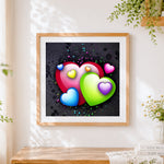 Finished colourful 3D hearts and vines cross stitch artwork displayed