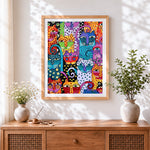 Finished colourful abstract pop art cats cross stitch artwork displayed