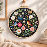 Colourful birds and wildflowers embroidery hoop wall art displayed as warm and cosy handmade home decor