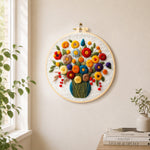 Colourful bouquet with berries needle felt wall art displayed in a bright home interior