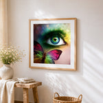 Colourful butterfly and green eye close up cross stitch artwork displayed on wall as home decor