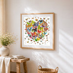 Colourful butterfly heart collage cross stitch artwork displayed on wall as home decor