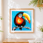 Finished colourful cartoon toucan cross stitch artwork displayed