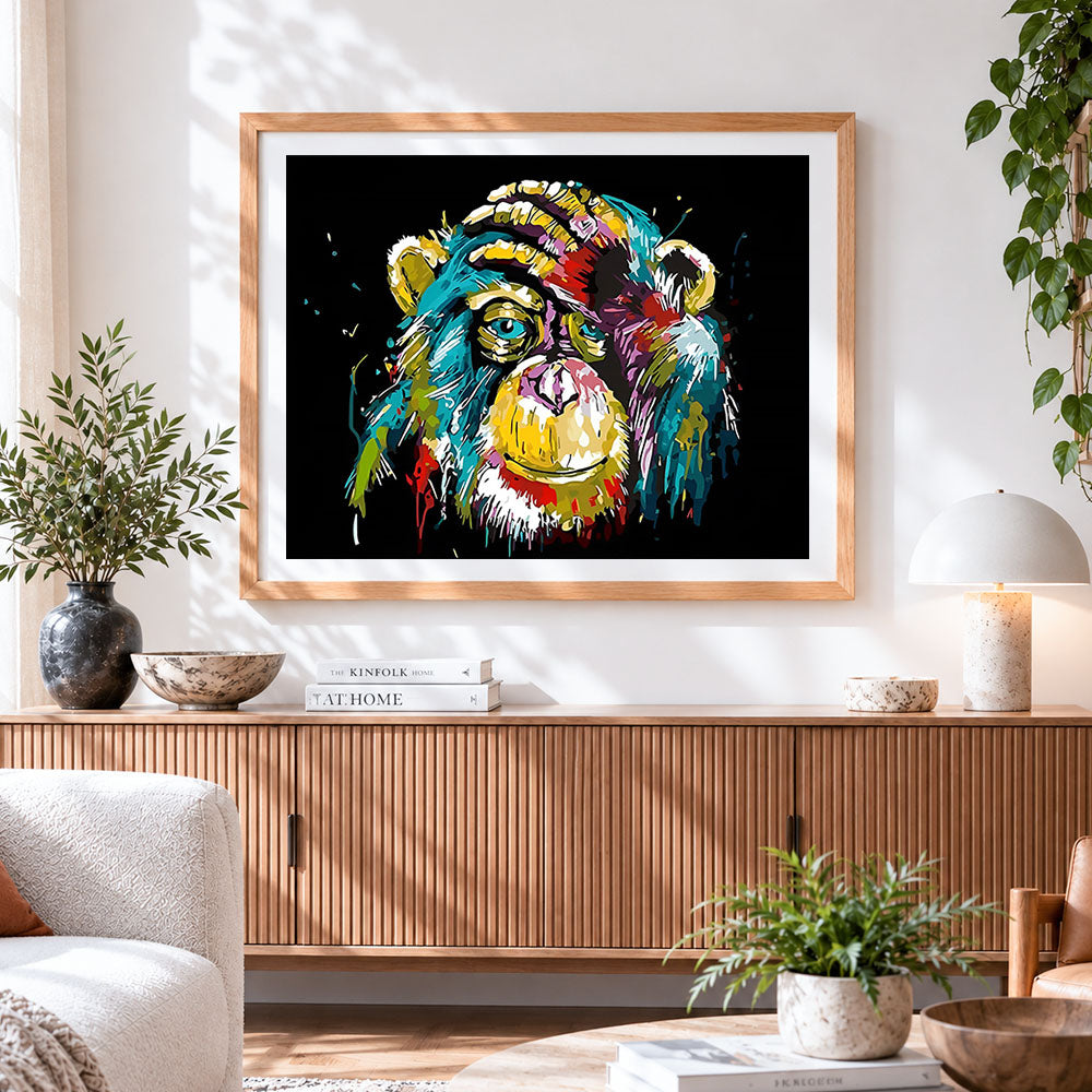 Finished colourful chimpanzee portrait cross stitch artwork displayed