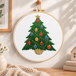 Colourful christmas tree embroidery hoop wall art displayed as warm and cozy handmade home decor