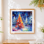Finished colourful christmas tree forest cross stitch artwork displayed