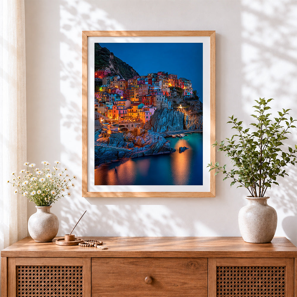 Finished colourful cinque terre at night cross stitch artwork displayed