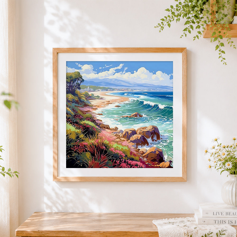 Finished colourful coastal cliffs and waves cross stitch artwork displayed