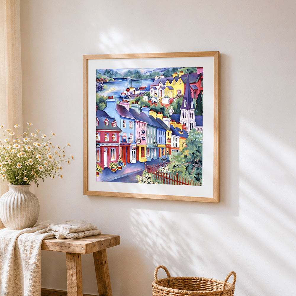 Colourful coastal town cross stitch artwork displayed on wall as home decor