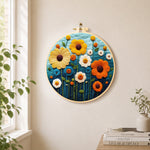 Colourful daisies on dark blue needle felt wall art displayed in a bright home interior