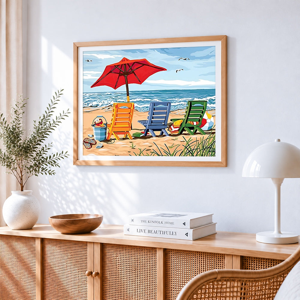 Colourful deck chairs on a sandy beach cross stitch artwork displayed on wall as home decor