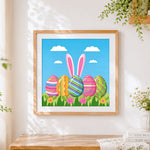 Finished colourful easter eggs and bunny ears cross stitch artwork displayed