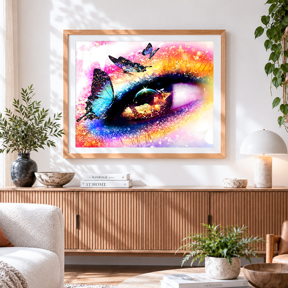 Finished colourful eye with butterflies cross stitch artwork displayed