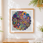 Finished colourful floral mandala collage cross stitch artwork displayed