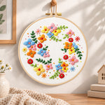 Colourful floral wreath embroidery hoop wall art displayed as warm and cosy handmade home decor