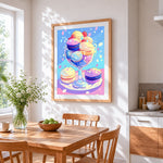 Colourful french macarons in a glass cross stitch artwork displayed on wall as home decor
