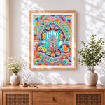 Finished colourful hamsa hand mandala cross stitch artwork displayed