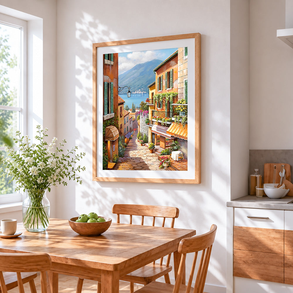 Colourful hillside village and café cross stitch artwork displayed on wall as home decor