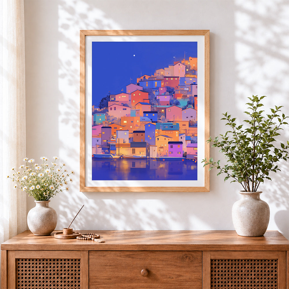 Finished colourful hillside village at night cross stitch artwork displayed
