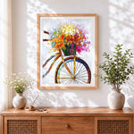 Finished colourful impasto bicycle with flower basket cross stitch artwork displayed