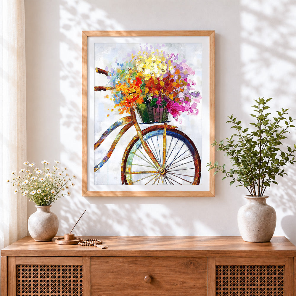 Finished colourful impasto bicycle with flower basket cross stitch artwork displayed
