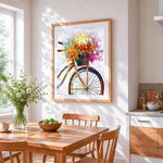 Colourful impasto bicycle with flower basket cross stitch artwork displayed on wall as home decor