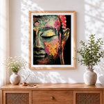 Finished colourful impasto buddha face cross stitch artwork displayed
