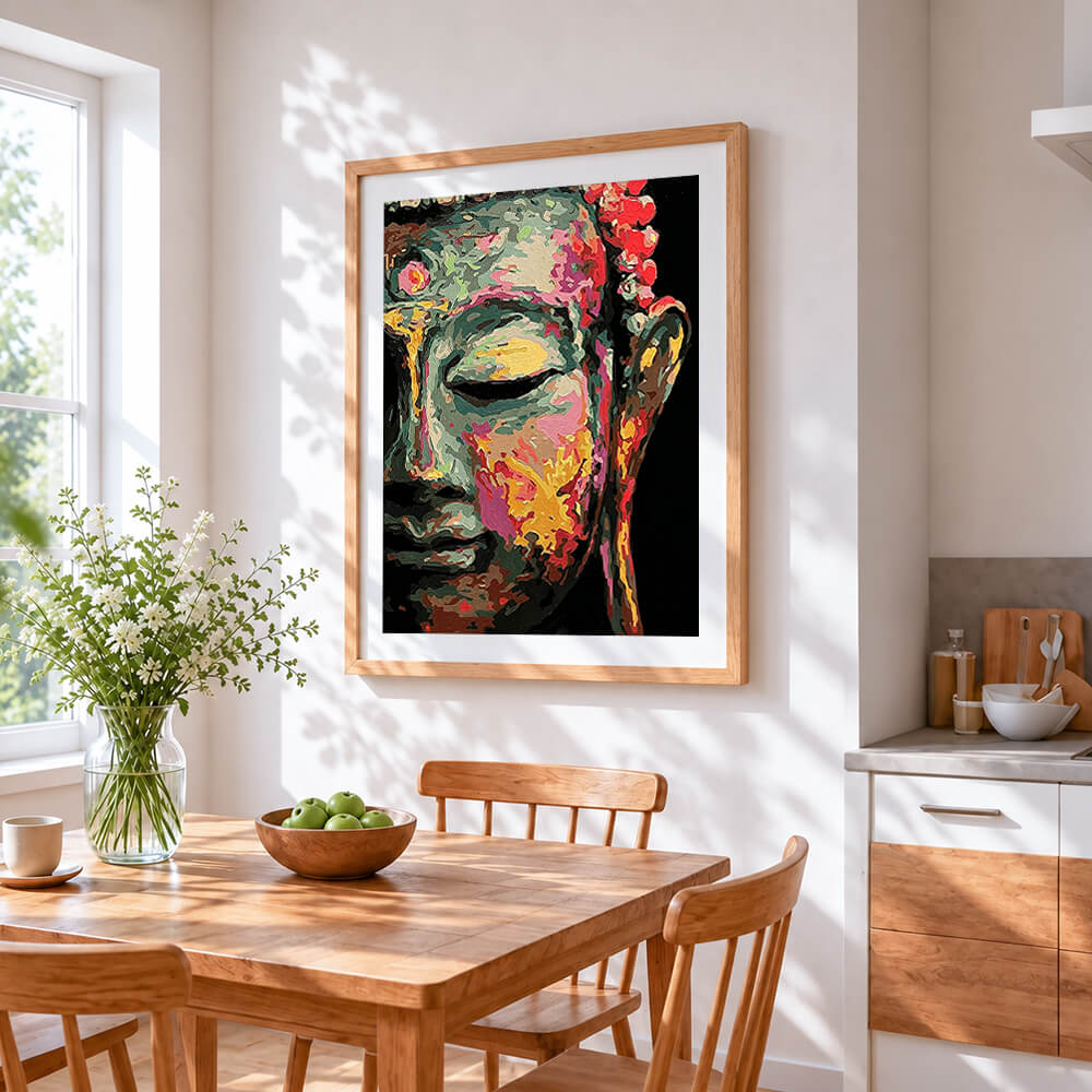 Colourful impasto buddha face cross stitch artwork displayed on wall as home decor