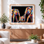 Finished colourful impasto elephant family cross stitch artwork displayed