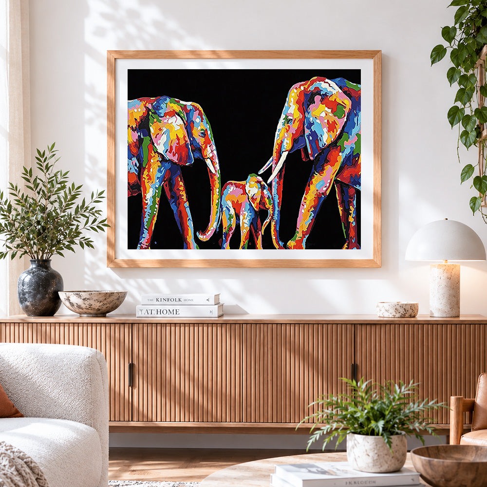 Finished colourful impasto elephant family cross stitch artwork displayed